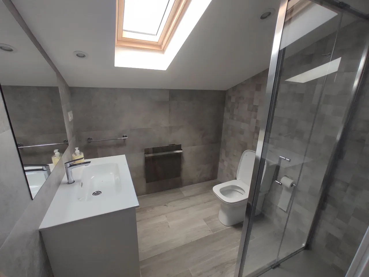 Upper-floor bathroom with shower and skylight