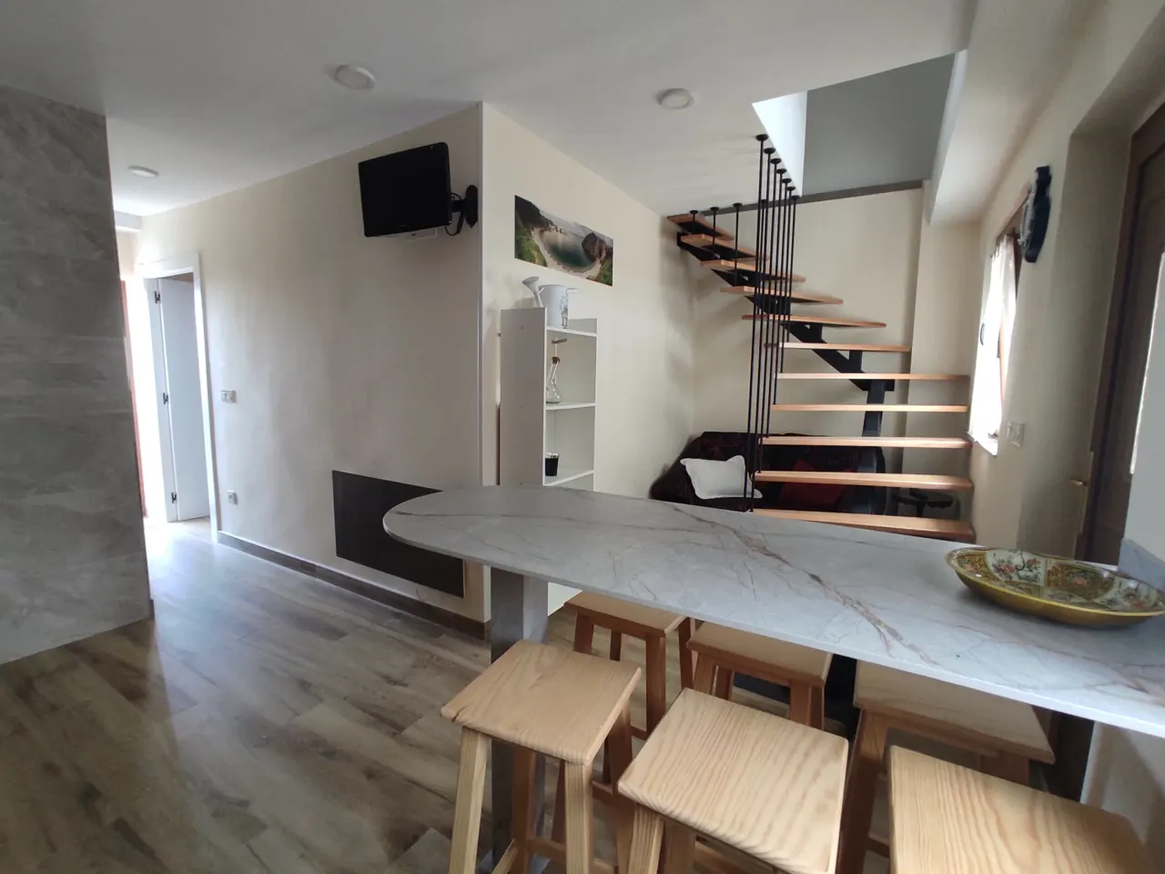 Kitchen with breakfast bar and stairs to the upper floor