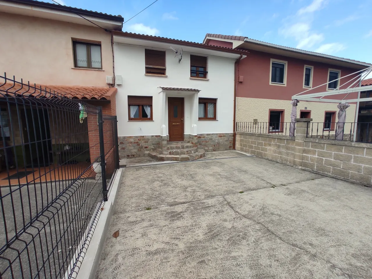 Enclosed front courtyard with private parking